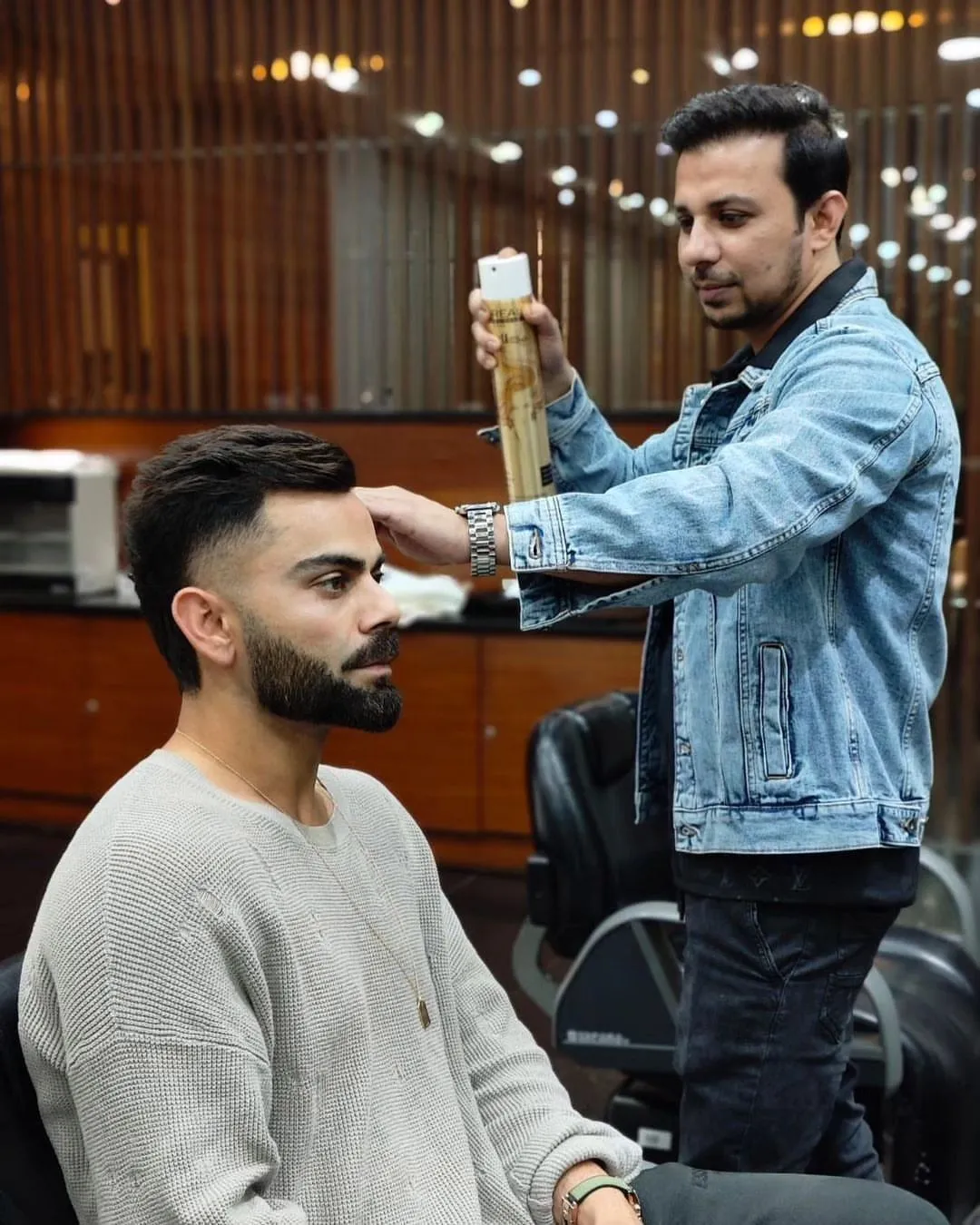 barber giving fade haircut to indian man like virat kohli