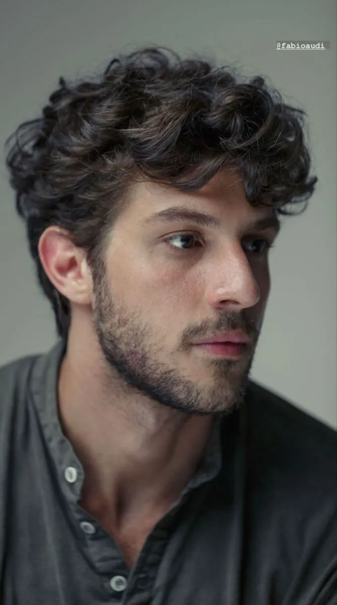 short messy curly hair fade profile for men