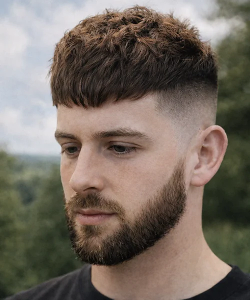 Textured fringe haircut for men growing hair out