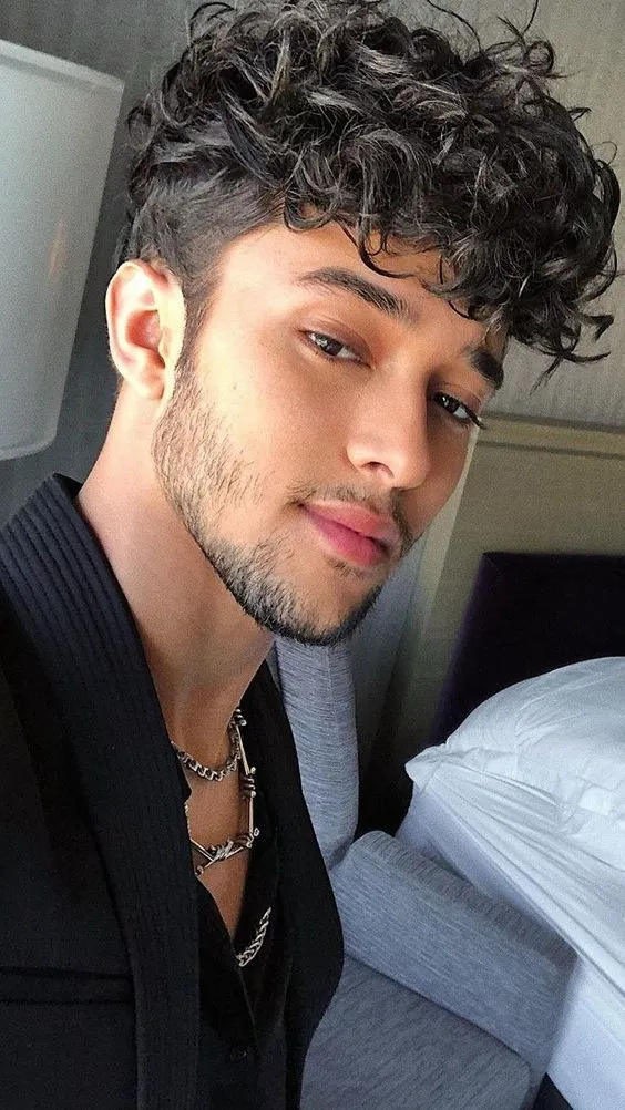 thick curly hairstyle for men close up